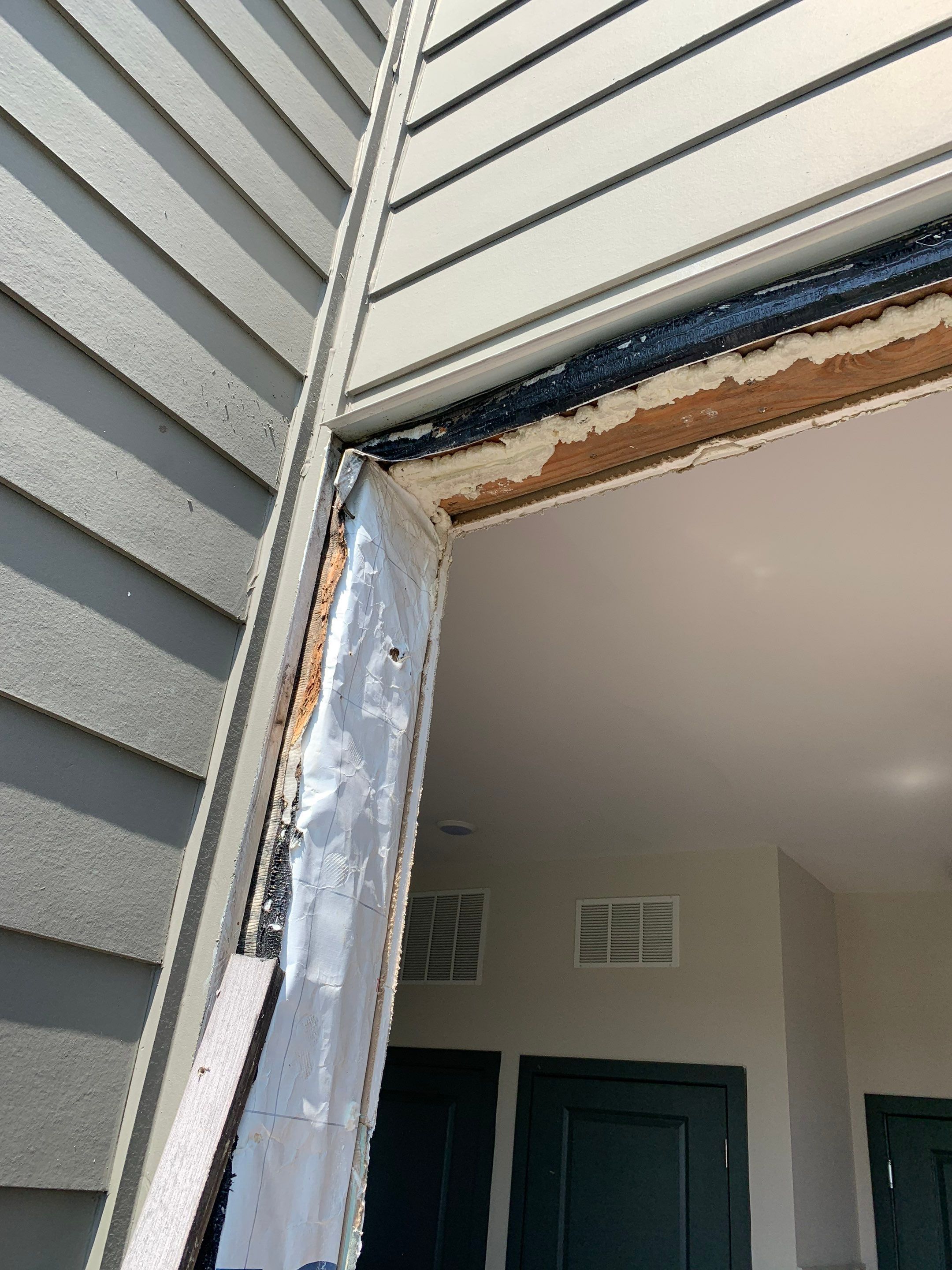 Exterior view of the upper door opening after removing the original doors and trim.