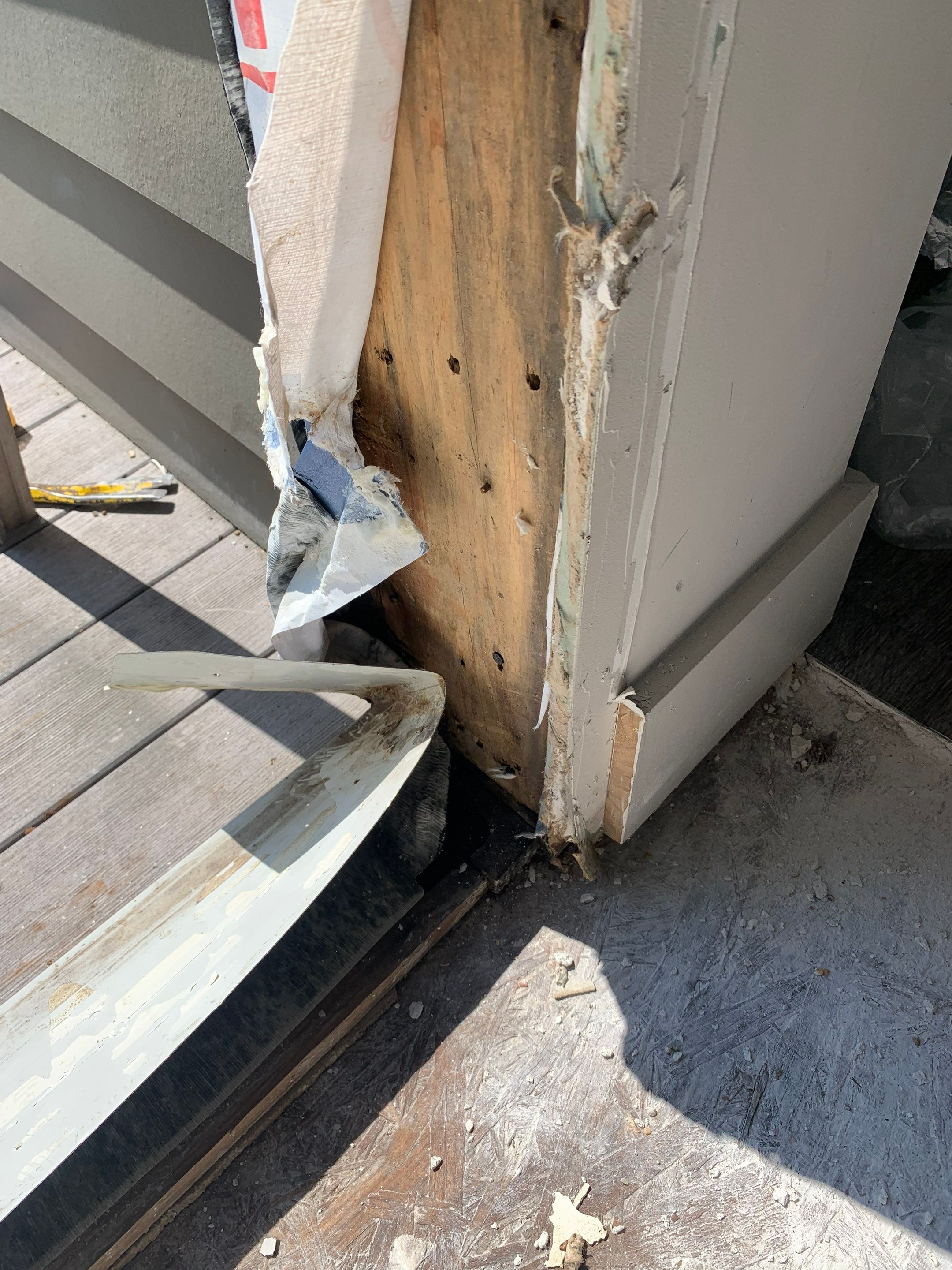 Existing framing exposed at the lower corner of the balcony doorway.