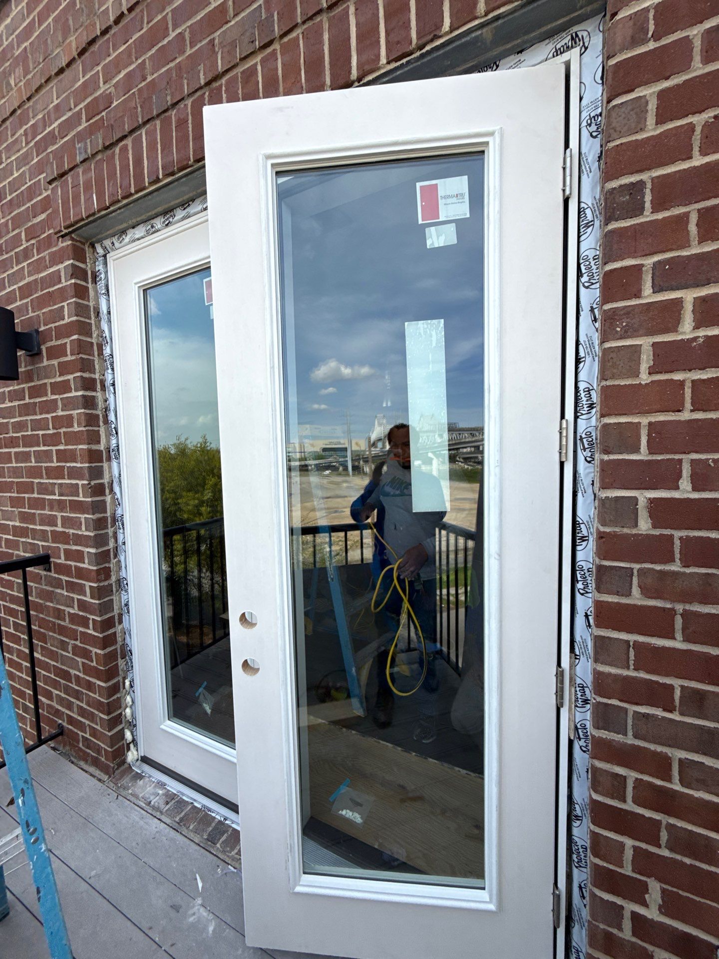 Replacement door swung open while installers finish the opening