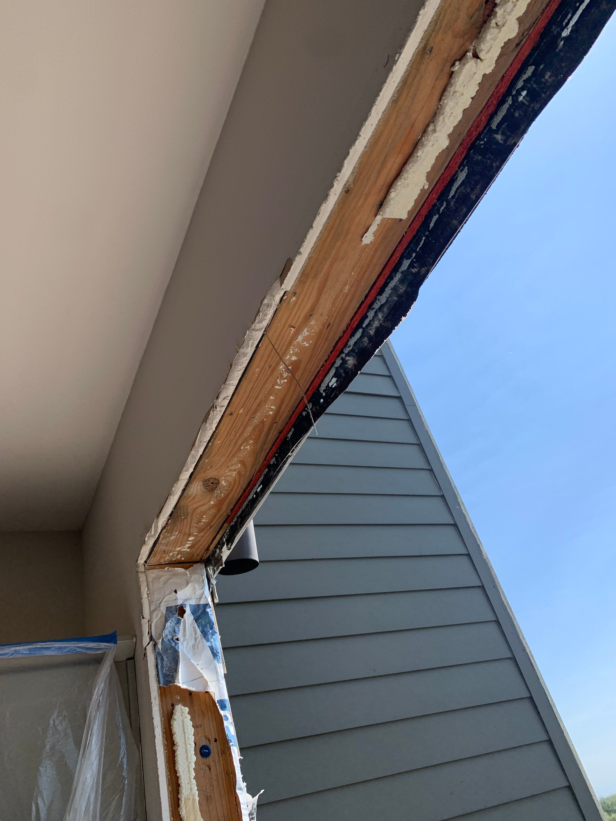 Upper door framing exposed after removing the original unit, revealing existing installation materials.