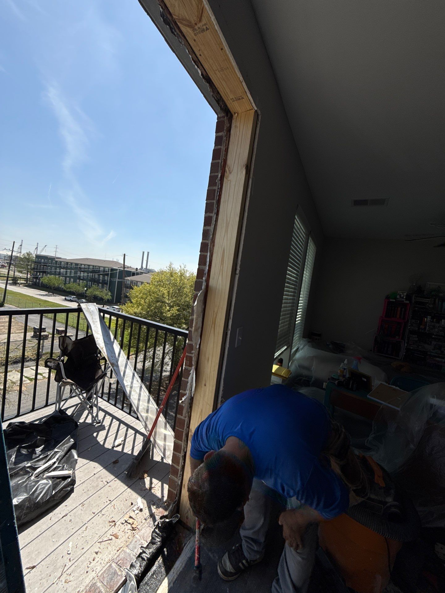 Worker inspecting exposed jamb at open doorway