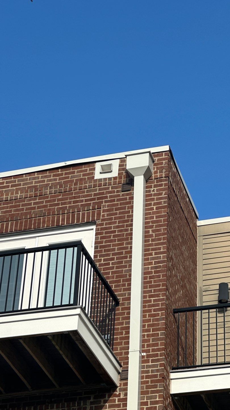 Building corner and roofline above balconies