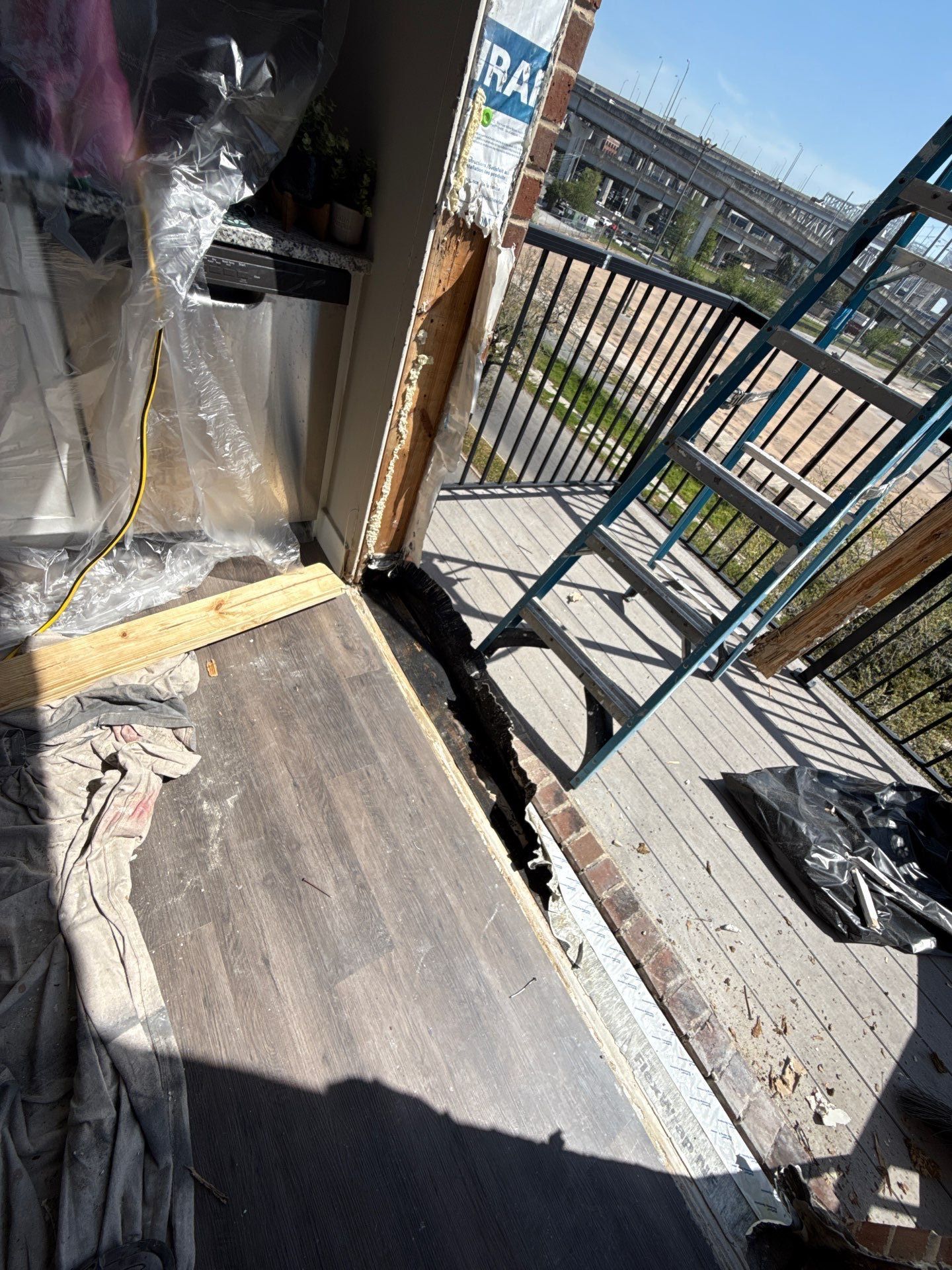 Exposed doorway, damaged sill and adjacent kitchen cabinets
