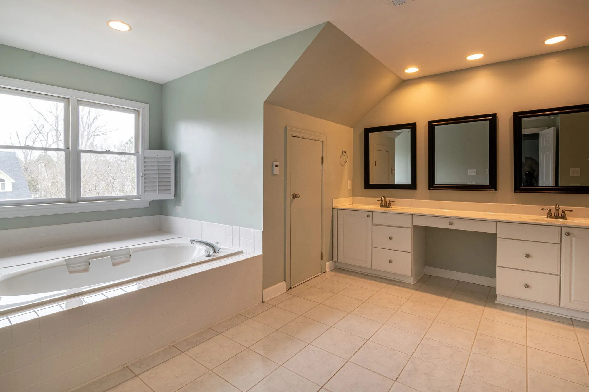 Large traditional bathroom with drop-in tub and long double vanity