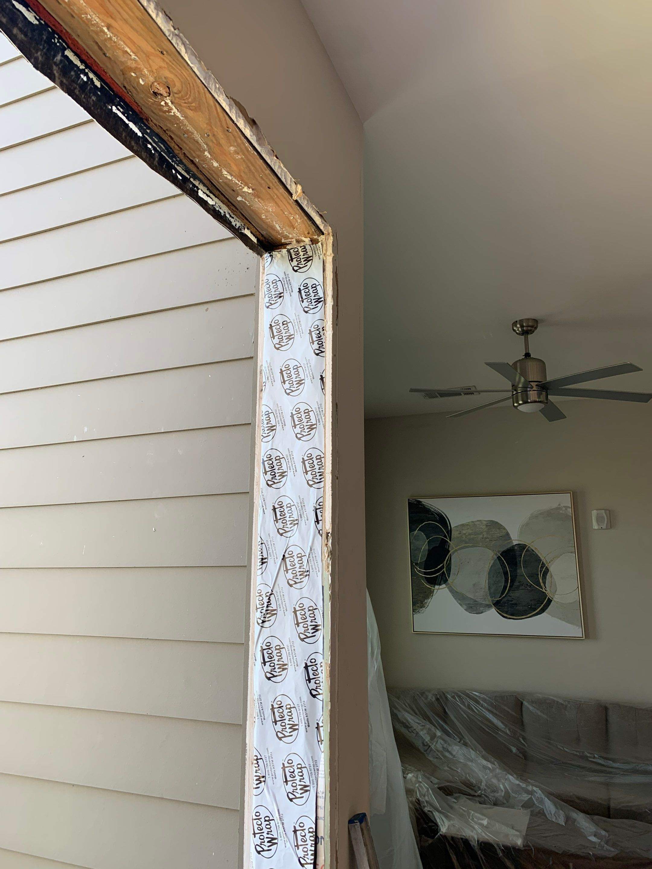 Interior view of the original door assembly and surrounding wall before finishing work.