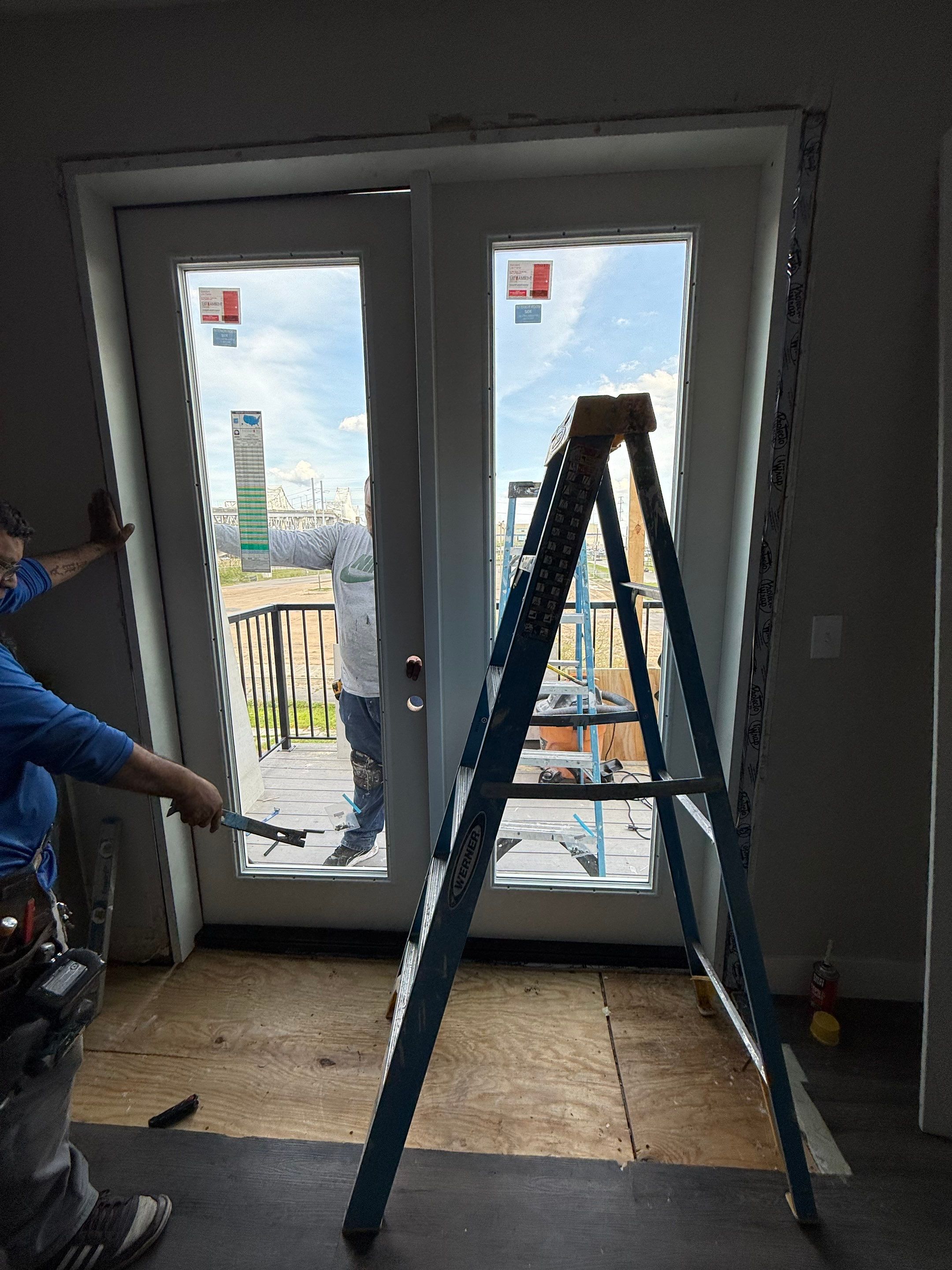 Detailed view of the flashing transition between the replacement door sill and surrounding brickwork