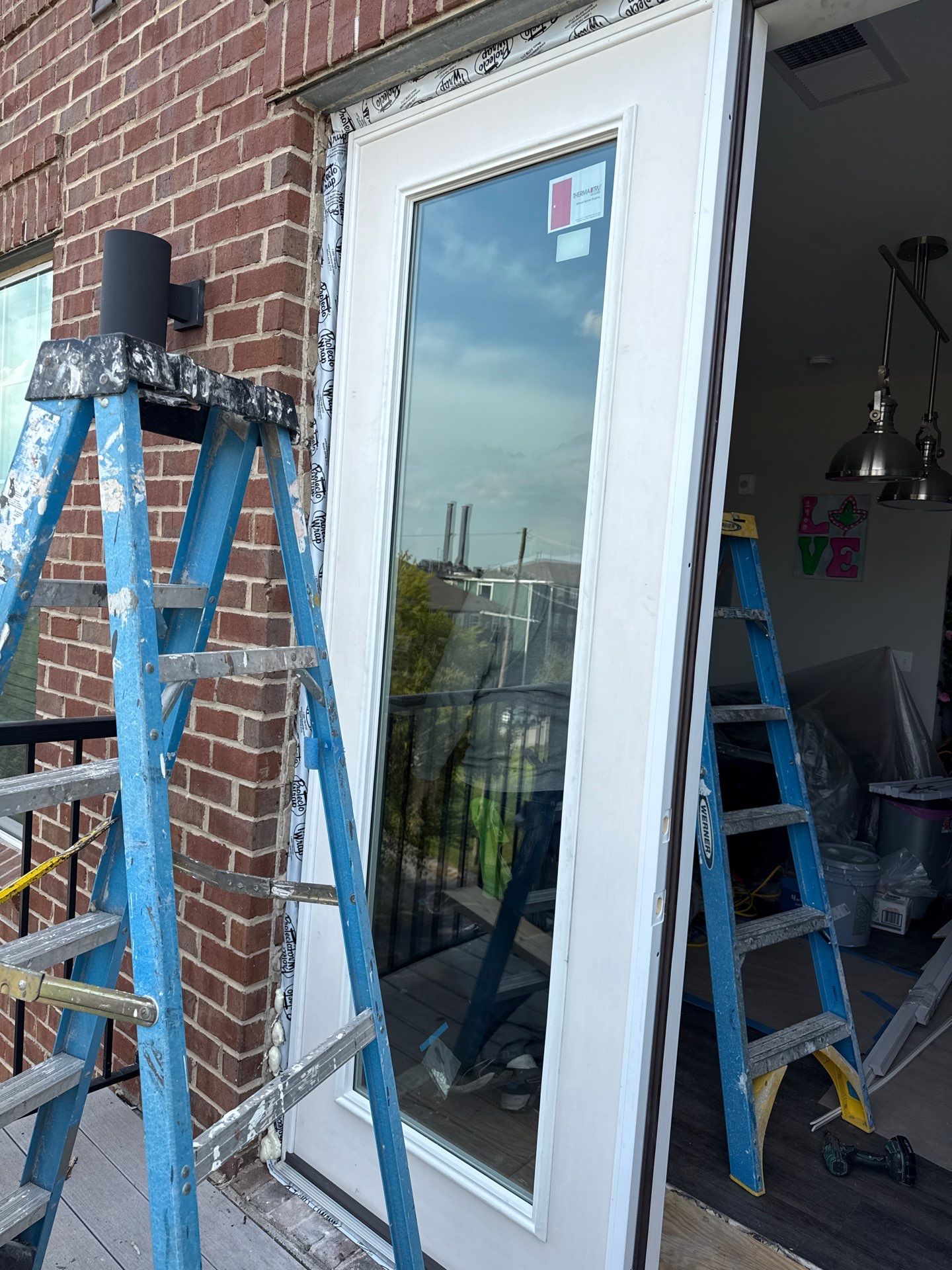 Replacement French door installed; exterior jamb wrapping still exposed