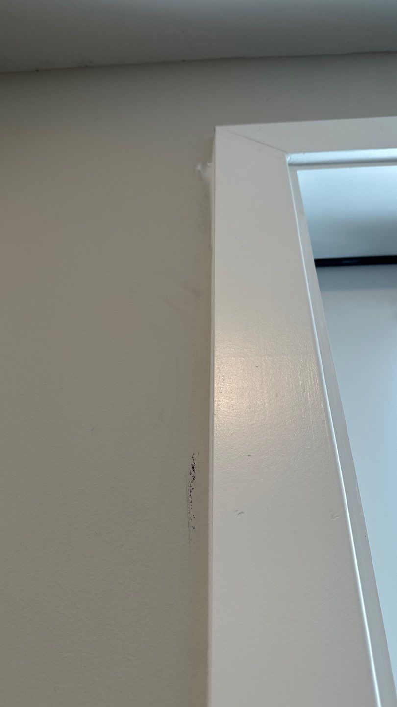 Wall seam and staining next to interior casing