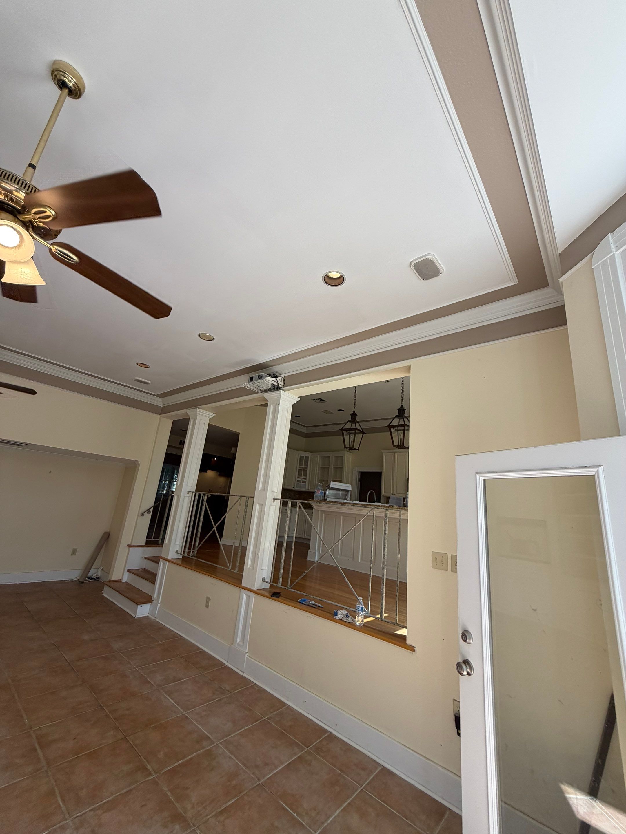 Completed ceiling restoration viewed from the opposite side of the den, with the existing architectural details preserved.