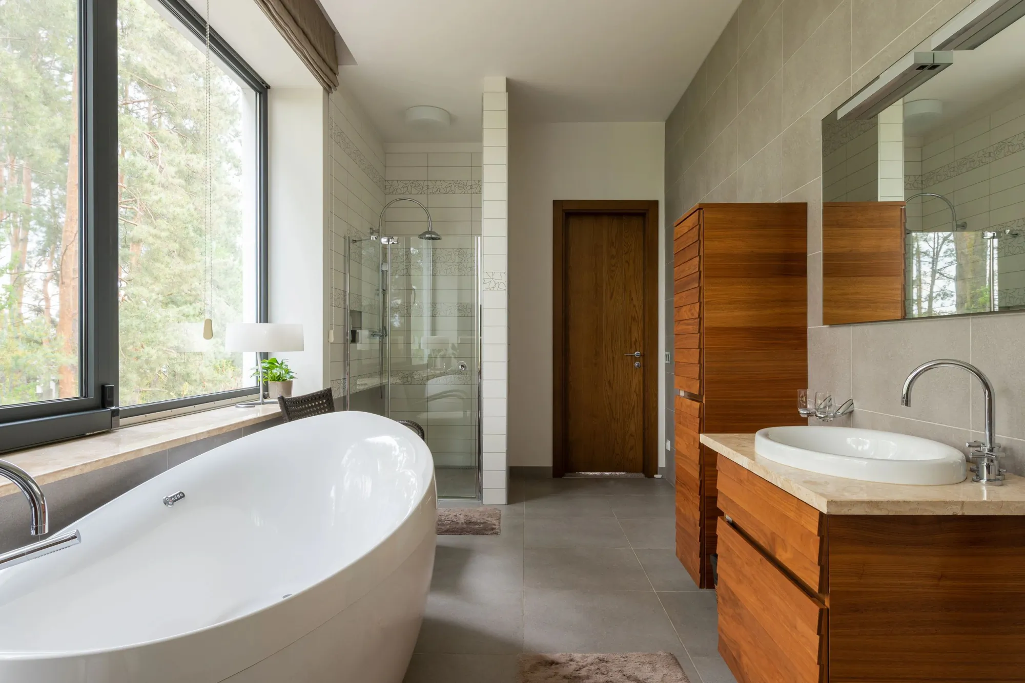 Modern bathroom with freestanding oval tub and floor-to-ceiling window