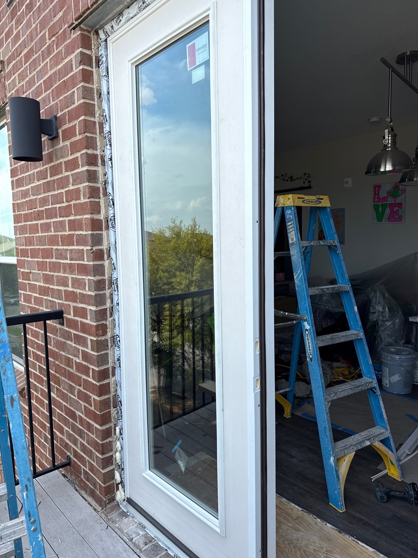 New French door shown open before exterior trim is finished