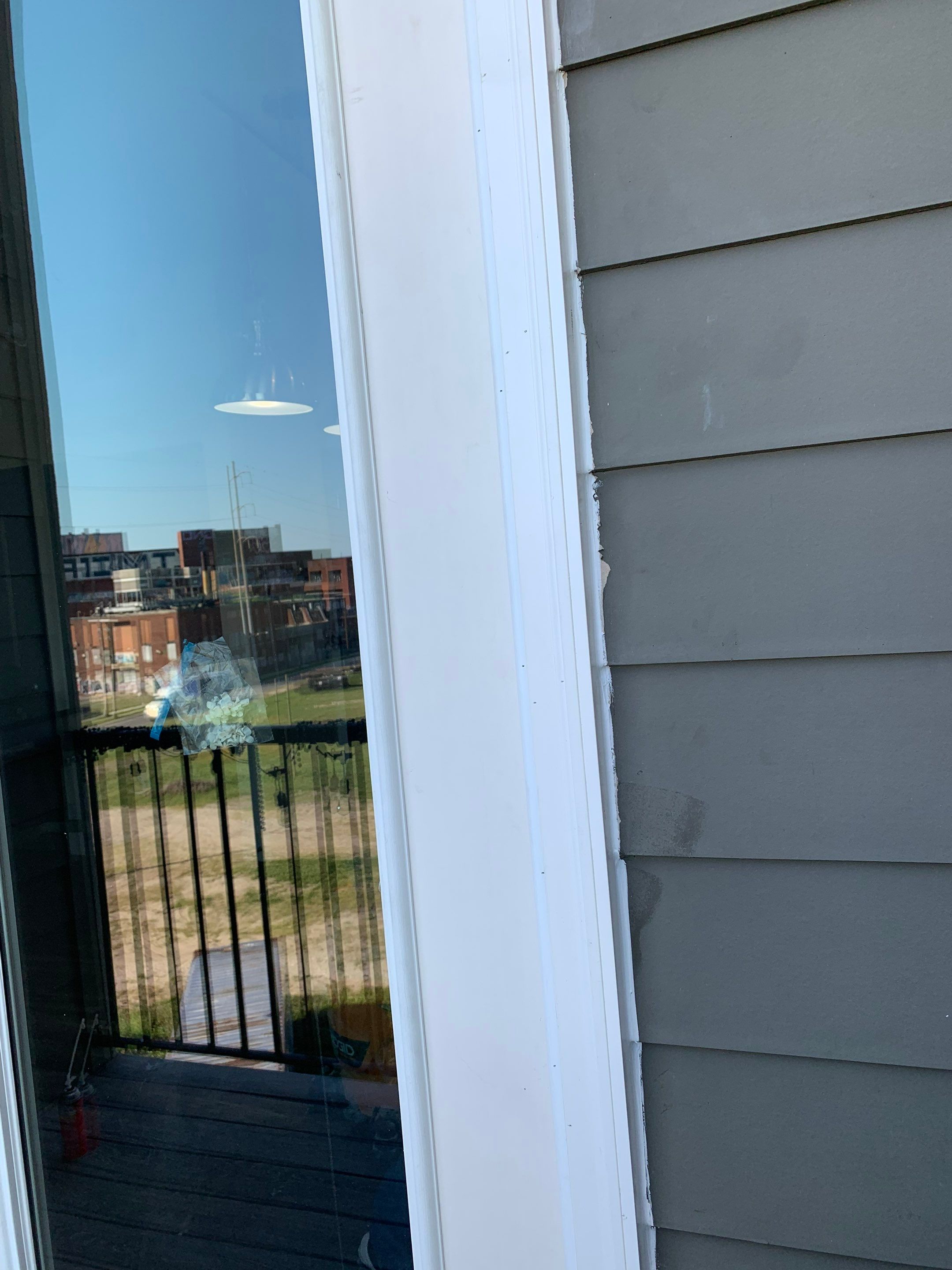 Close-up of the finished exterior door trim and adjacent siding